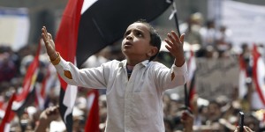 A boy prays during a demonstration at Tahrir Square in Cairo
